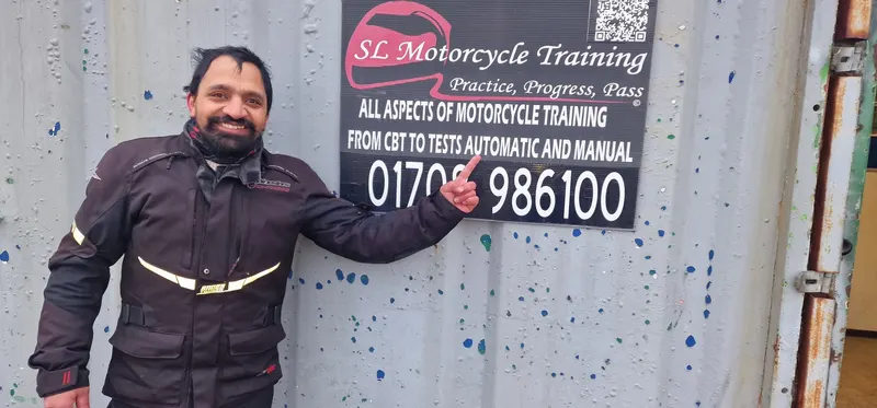 A student pointing at the SL phone number on the sign