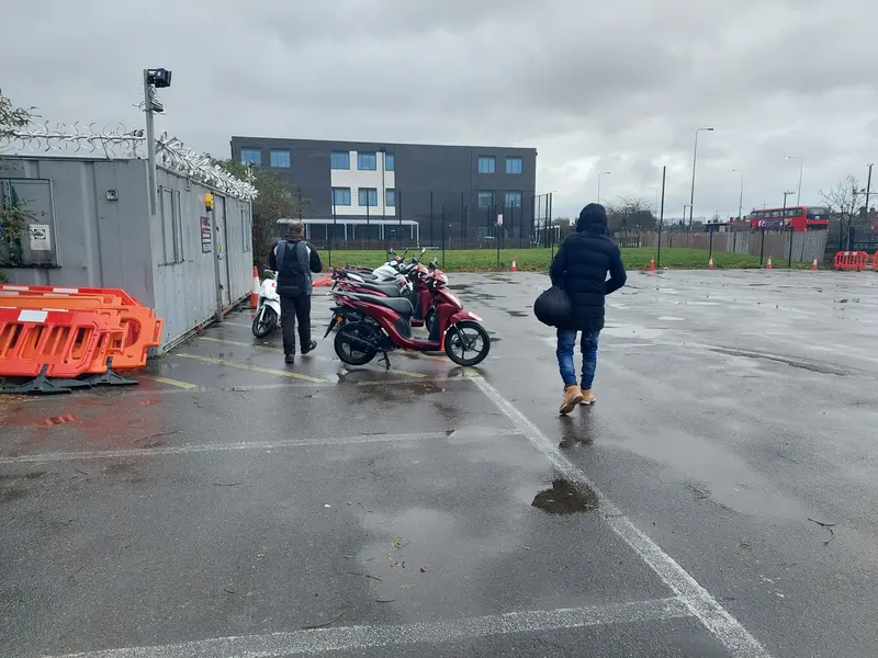 Learners walking across the training ground to the bikes