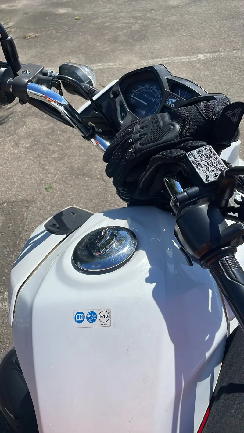 Close-up of a motorbike's fuel tank and handlebars