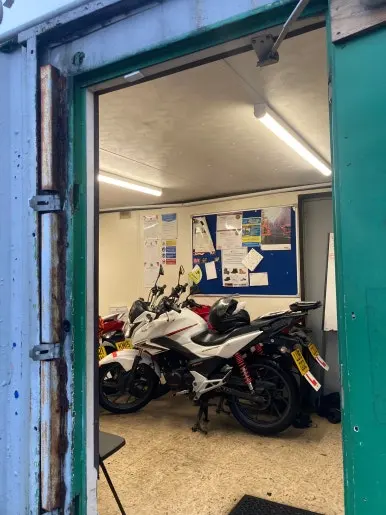 Training motorbikes parked inside the building