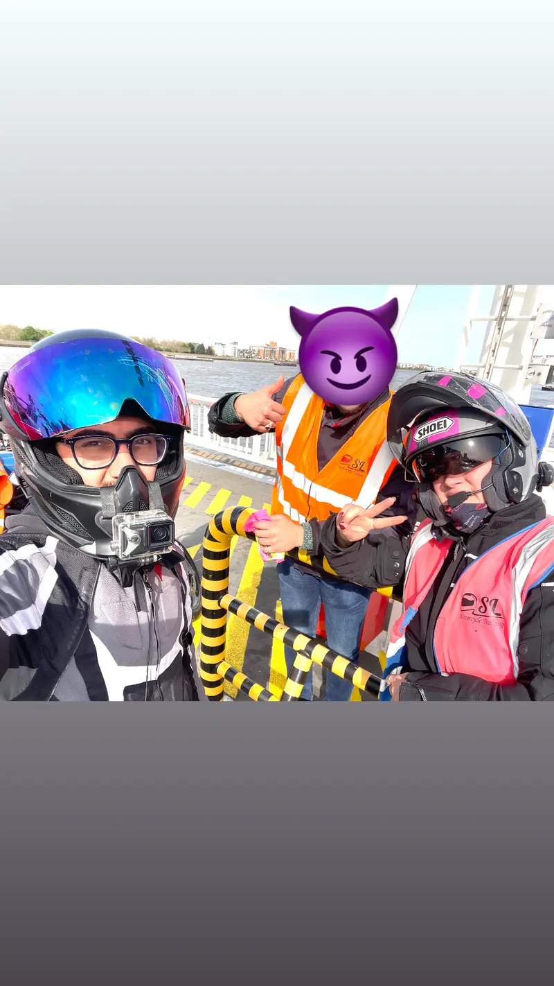 Two riders in helmets and vests posing together