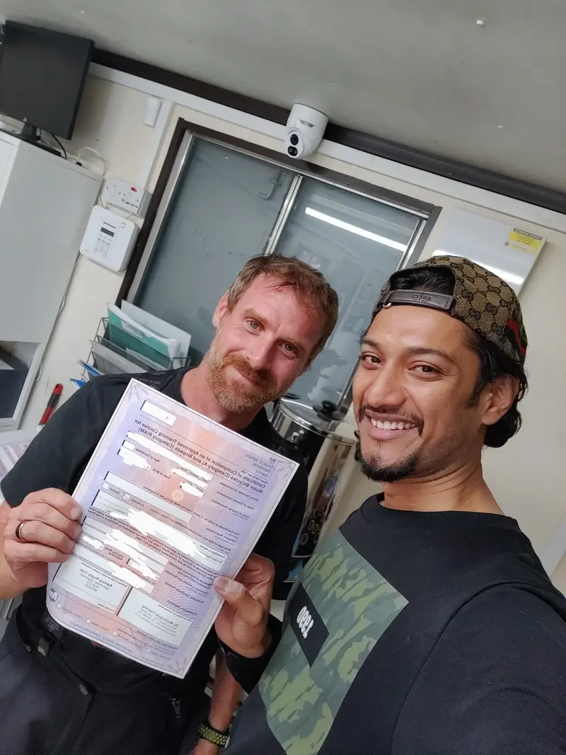 A student and instructor with a pass certificate