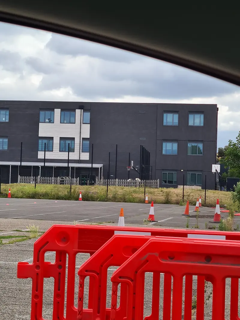 The training ground with cones, and the building behind